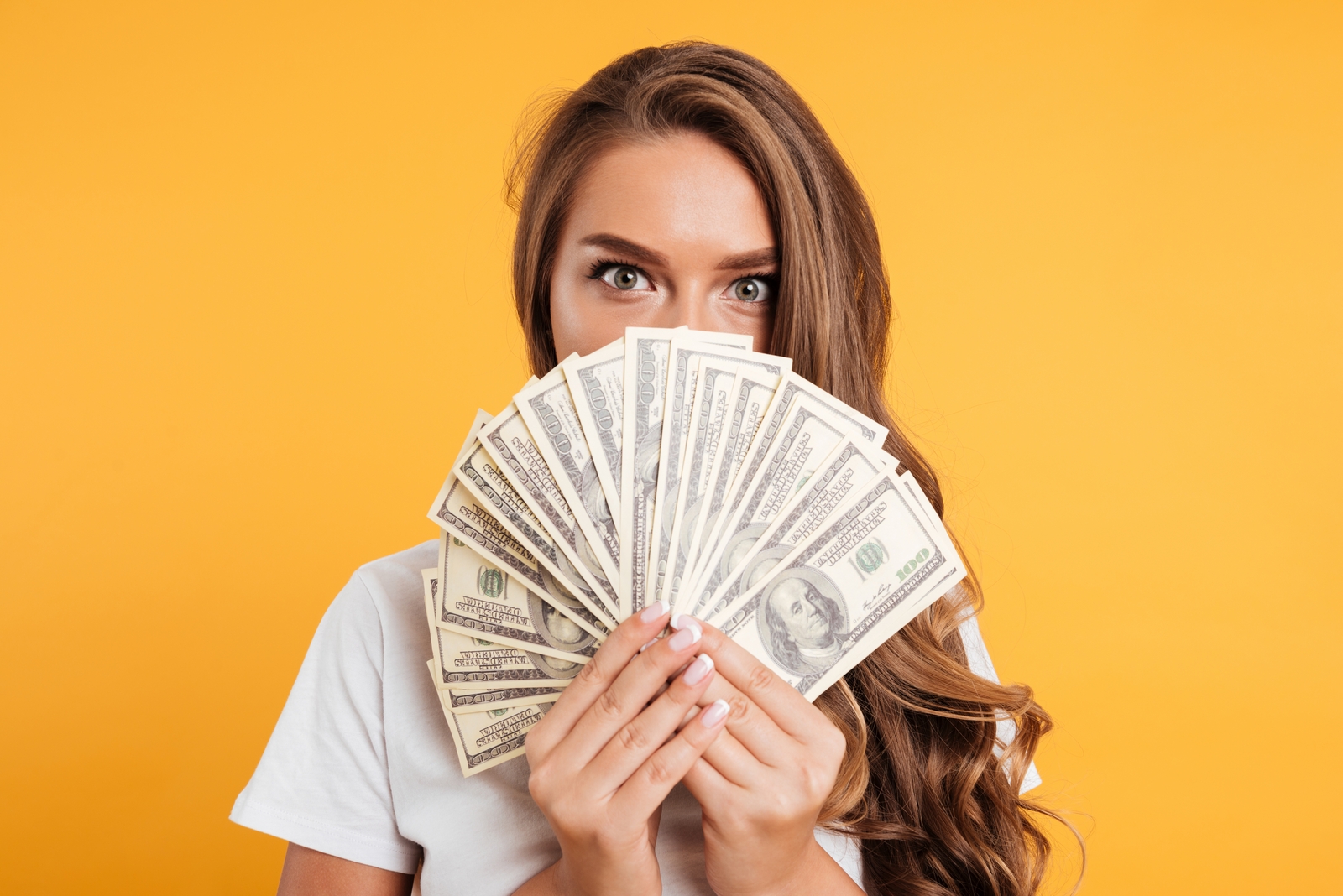 Frau mit Geldscheinen auf gelborangen Hintergrund